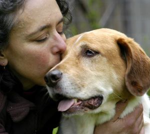 woman kissing dog